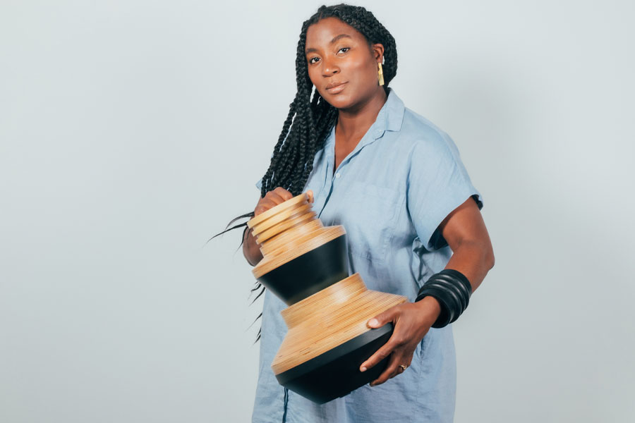 contemporary designer Simone Brewster at now gallery with a wooden vase