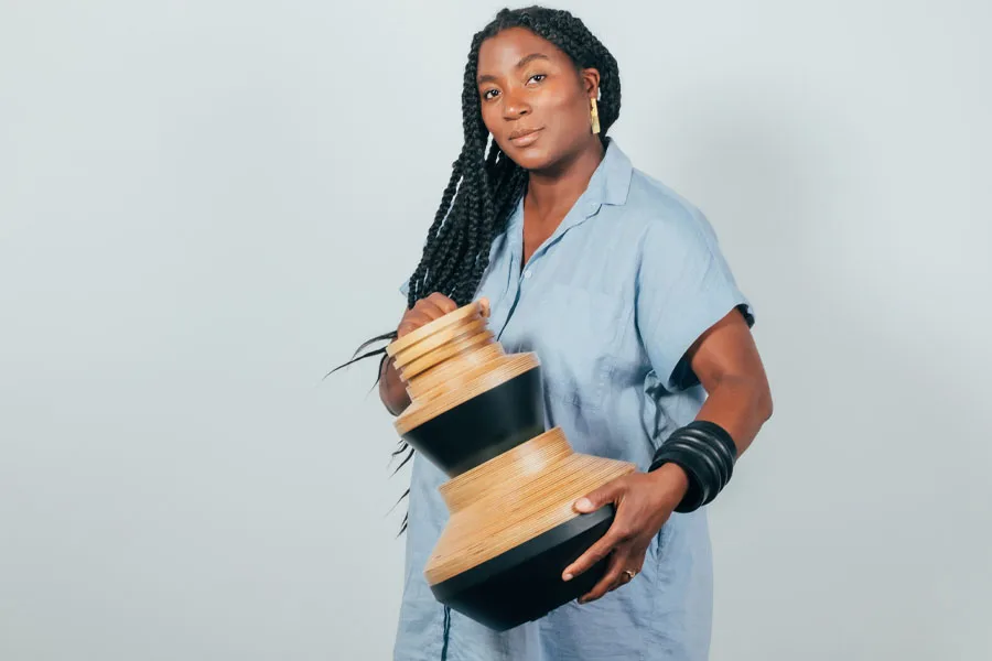 contemporary designer Simone Brewster at now gallery with a wooden vase